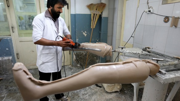 An Afghan employee of the International Committee of the Red Cross (ICRC) works on a prosthetic leg at the ICRC physical rehabilitation center in Kabul, Afghanistan, Tuesday, May 10, 2016. Afghanistan is one of the world's most heavily mined countries. (AP Photo/Rahmat Gul)